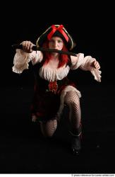 DARINA KNEELING POSES WITH DAGGER 